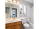 Bathroom with wood vanity, white countertop and bathtub/shower combo at 6654 Coronado Crest Ave, Las Vegas, NV 89139