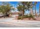 Single-story home with a tile roof, two-car garage, and drought tolerant landscaping at 6654 Coronado Crest Ave, Las Vegas, NV 89139