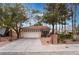 Charming single-story home featuring a tile roof, two-car garage, and mature landscaping at 6654 Coronado Crest Ave, Las Vegas, NV 89139