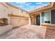 View of front entry featuring brick walkway and outdoor fireplace at 6654 Coronado Crest Ave, Las Vegas, NV 89139