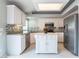 Bright kitchen with stainless steel appliances, white cabinets, backsplash, and island at 6654 Coronado Crest Ave, Las Vegas, NV 89139