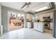 Stylish kitchen with stainless steel appliances, white cabinets, island, and patio access at 6654 Coronado Crest Ave, Las Vegas, NV 89139