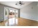 Bright living room with wood floors, neutral paint, ceiling fan and sliding glass door to backyard at 6654 Coronado Crest Ave, Las Vegas, NV 89139