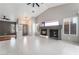 Spacious living room with tile flooring, cozy fireplace, and ample windows at 6654 Coronado Crest Ave, Las Vegas, NV 89139