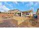 A spacious backyard features a fire pit, covered patio, seating, and desert landscaping at 7115 Calvert Cliffs St, North Las Vegas, NV 89084