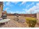 Landscaped backyard with desert landscaping, a dining area, and a gazebo, perfect for outdoor entertaining at 7115 Calvert Cliffs St, North Las Vegas, NV 89084