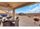 Charming backyard patio area with ceiling fan, dining area, BBQ, and firepit at 7115 Calvert Cliffs St, North Las Vegas, NV 89084