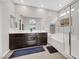 Elegant bathroom featuring a soaking tub, glass shower, double vanity, and tasteful decor at 7115 Calvert Cliffs St, North Las Vegas, NV 89084