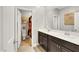 A well-lit bathroom with double sinks, dark cabinets, and a separate toilet area at 7115 Calvert Cliffs St, North Las Vegas, NV 89084