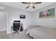 This bedroom has a ceiling fan, study space, and neutral wall color at 7115 Calvert Cliffs St, North Las Vegas, NV 89084
