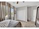 Comfortable bedroom with a large window, neutral color scheme, and a spacious closet at 7115 Calvert Cliffs St, North Las Vegas, NV 89084