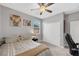 A cozy bedroom features a ceiling fan, large closet, and comfortable bed at 7115 Calvert Cliffs St, North Las Vegas, NV 89084