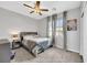 Cozy bedroom featuring a ceiling fan, neutral decor, and a view of the neighborhood at 7115 Calvert Cliffs St, North Las Vegas, NV 89084