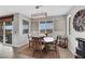 Inviting dining area with a wooden table, neutral walls, and natural light streaming through the large windows at 7115 Calvert Cliffs St, North Las Vegas, NV 89084