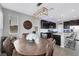 Charming dining area with a wooden table, chandelier lighting, and a view of the kitchen's dark cabinets and island at 7115 Calvert Cliffs St, North Las Vegas, NV 89084