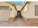 Inviting home entrance with a brick path leading to the front door and a two car garage at 7115 Calvert Cliffs St, North Las Vegas, NV 89084