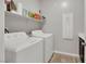 Bright laundry area with washer, dryer, shelf and storage at 7115 Calvert Cliffs St, North Las Vegas, NV 89084