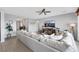 Comfortable living room featuring a large sectional sofa, modern decor, and ample natural light from nearby windows at 7115 Calvert Cliffs St, North Las Vegas, NV 89084