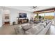 Bright living room featuring a plush sectional sofa, entertainment center, and sliding glass doors to the outdoor patio at 7115 Calvert Cliffs St, North Las Vegas, NV 89084