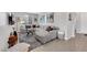 Living room with stylish decor, a plush gray sectional, and view to the hallway at 7115 Calvert Cliffs St, North Las Vegas, NV 89084