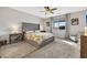 Serene main bedroom with a tufted headboard, neutral decor, and a cozy, carpeted floor at 7115 Calvert Cliffs St, North Las Vegas, NV 89084