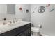 Charming powder room featuring a black vanity with marble countertop and modern fixtures at 7386 Campbell Ranch Ave, Las Vegas, NV 89179