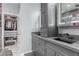 Bathroom with dual sinks, gray cabinets and a separate walk-in closet at 7386 Campbell Ranch Ave, Las Vegas, NV 89179