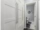Hallway bathroom featuring white cabinets, modern fixtures, and a toilet room in view at 7386 Campbell Ranch Ave, Las Vegas, NV 89179