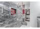 Modern bathroom featuring tiled shower with niche, adjacent to walk-in closet for ample storage at 7386 Campbell Ranch Ave, Las Vegas, NV 89179