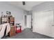 Bedroom with gray walls and carpet, featuring a built-in desk and closet with sliding doors at 7386 Campbell Ranch Ave, Las Vegas, NV 89179