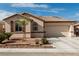 Well-maintained home with a stone-accented garden bed, neutral paint, and a two-car garage at 7386 Campbell Ranch Ave, Las Vegas, NV 89179