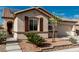 Home with stone accents, brown shutters, desert landscaping, and a two-car garage at 7386 Campbell Ranch Ave, Las Vegas, NV 89179