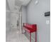 Modern hallway featuring sleek, red accent piano at 7386 Campbell Ranch Ave, Las Vegas, NV 89179