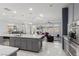 Modern kitchen seamlessly opens to the living area, featuring a large island and stainless steel appliances at 7386 Campbell Ranch Ave, Las Vegas, NV 89179