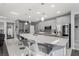 Modern kitchen features a large island with seating, stainless steel appliances, and stylish pendant lighting at 7386 Campbell Ranch Ave, Las Vegas, NV 89179