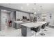 Contemporary kitchen boasting a spacious island with barstools and neutral-toned cabinets at 7386 Campbell Ranch Ave, Las Vegas, NV 89179