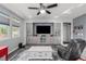 Large living room with wall storage, hardwood floors, and bright natural light at 7386 Campbell Ranch Ave, Las Vegas, NV 89179
