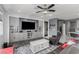 Living room with built-in shelves, modern ceiling fan and neutral-colored decor at 7386 Campbell Ranch Ave, Las Vegas, NV 89179