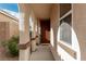 Covered porch with decorative columns and a dark wood front door entrance at 7386 Campbell Ranch Ave, Las Vegas, NV 89179