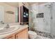 Modern bathroom featuring a glass shower with stylish tile and a built-in shelving unit for storage at 75 E Agate Ave # 204, Las Vegas, NV 89123