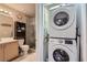 Modern bathroom featuring a glass shower with stylish tile and a stacked washer and dryer at 75 E Agate Ave # 204, Las Vegas, NV 89123