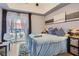 Cozy bedroom with balcony access, hardwood floors, and a calming color scheme at 75 E Agate Ave # 204, Las Vegas, NV 89123