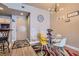 Cozy dining area featuring a glass table, colorful chairs, and decorative wall art at 75 E Agate Ave # 204, Las Vegas, NV 89123