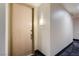 Condo unit entryway with a light wood door and a wall sconce at 75 E Agate Ave # 204, Las Vegas, NV 89123