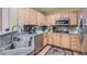 Kitchen with stainless steel appliances, granite countertops, and wood cabinetry at 75 E Agate Ave # 204, Las Vegas, NV 89123