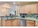Kitchen area with granite countertops, stainless steel appliances, and a view of the dining area at 75 E Agate Ave # 204, Las Vegas, NV 89123