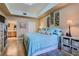Well-lit main bedroom with a large bed, access to the ensuite bathroom and wooden floors for a cozy feel at 75 E Agate Ave # 204, Las Vegas, NV 89123
