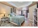 Comfortable main bedroom with light wood flooring, a cozy area rug and a large bed with soft blue linens at 75 E Agate Ave # 204, Las Vegas, NV 89123