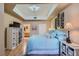 Inviting main bedroom with a large bed, tv, and wooden floors with access to the ensuite bathroom at 75 E Agate Ave # 204, Las Vegas, NV 89123