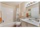 Bathroom with bathtub, toilet, sink, and white tile surround at 7945 Delbonita Ave, Las Vegas, NV 89147